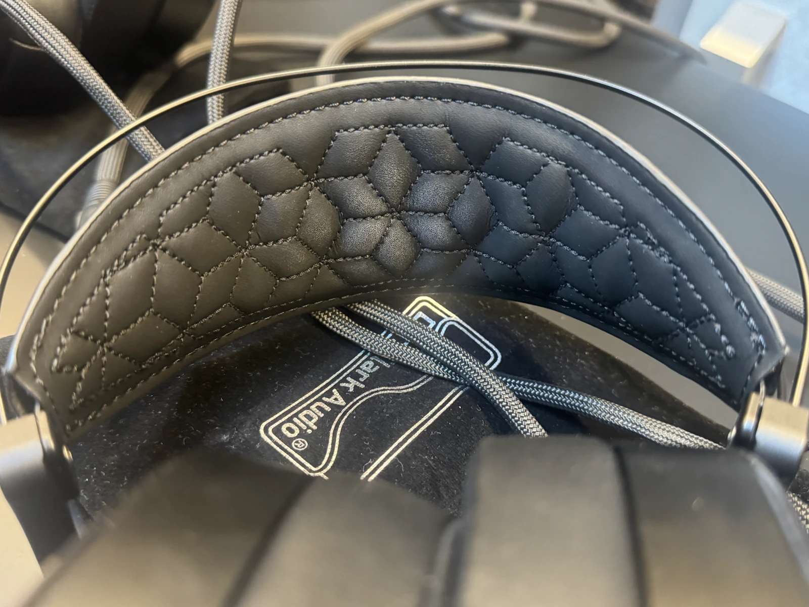 Dan Clark Audio NOIRE X headphones showing the padded stitched headband and adjustable fit