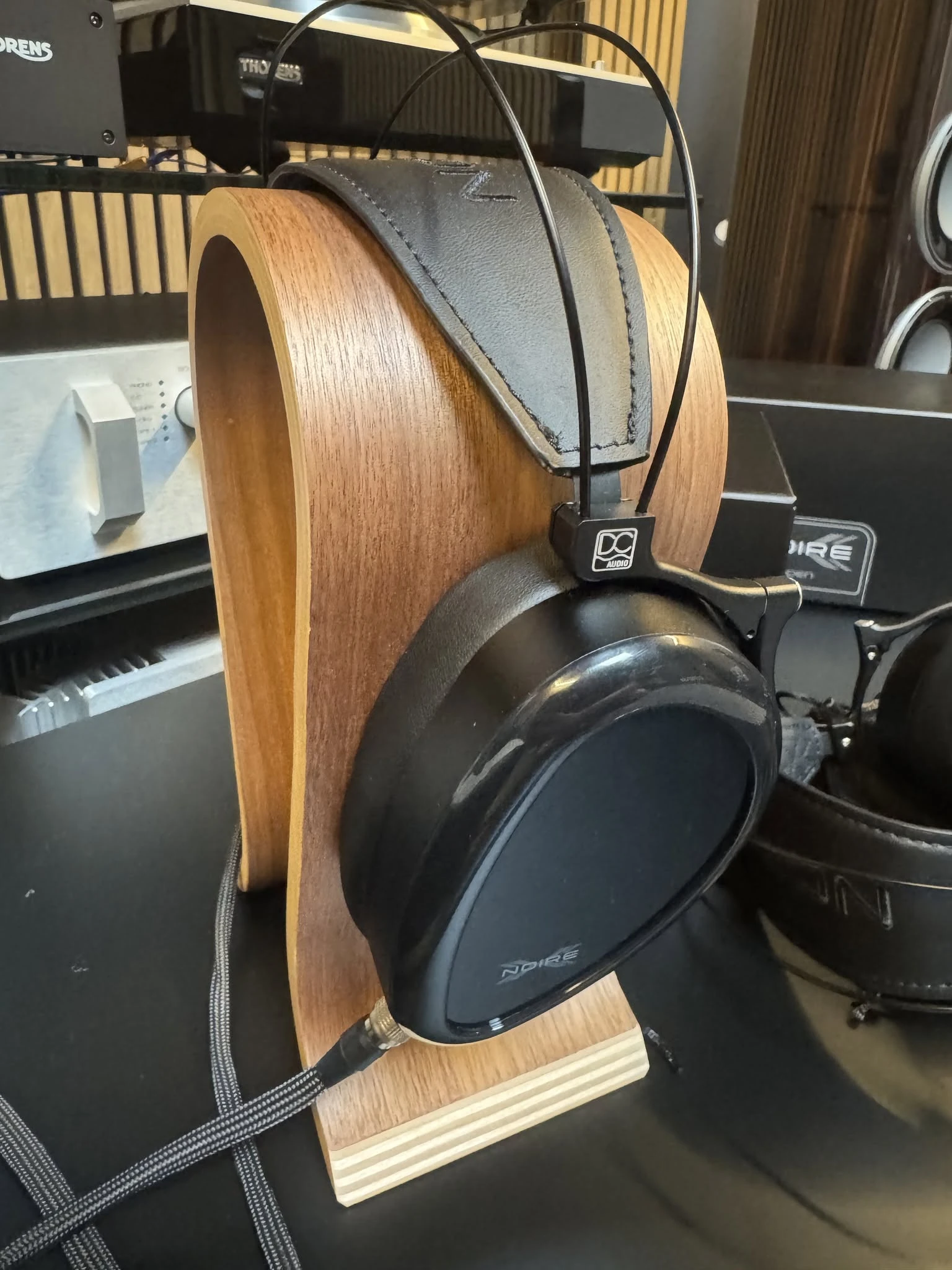 Dan Clark Audio NOIRE X closed-back headphones on a stand with VIVO cable at Hi-Fi Market