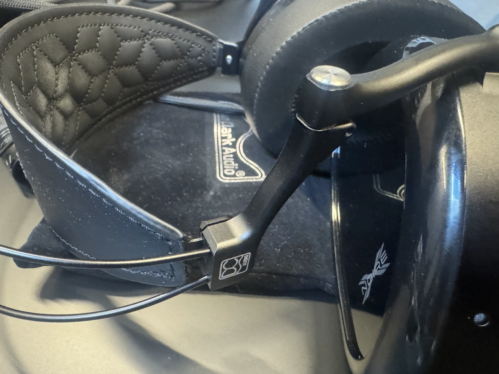Dan Clark Audio NOIRE X closed-back headphones showing the metal headband structure and pivot mechanisms