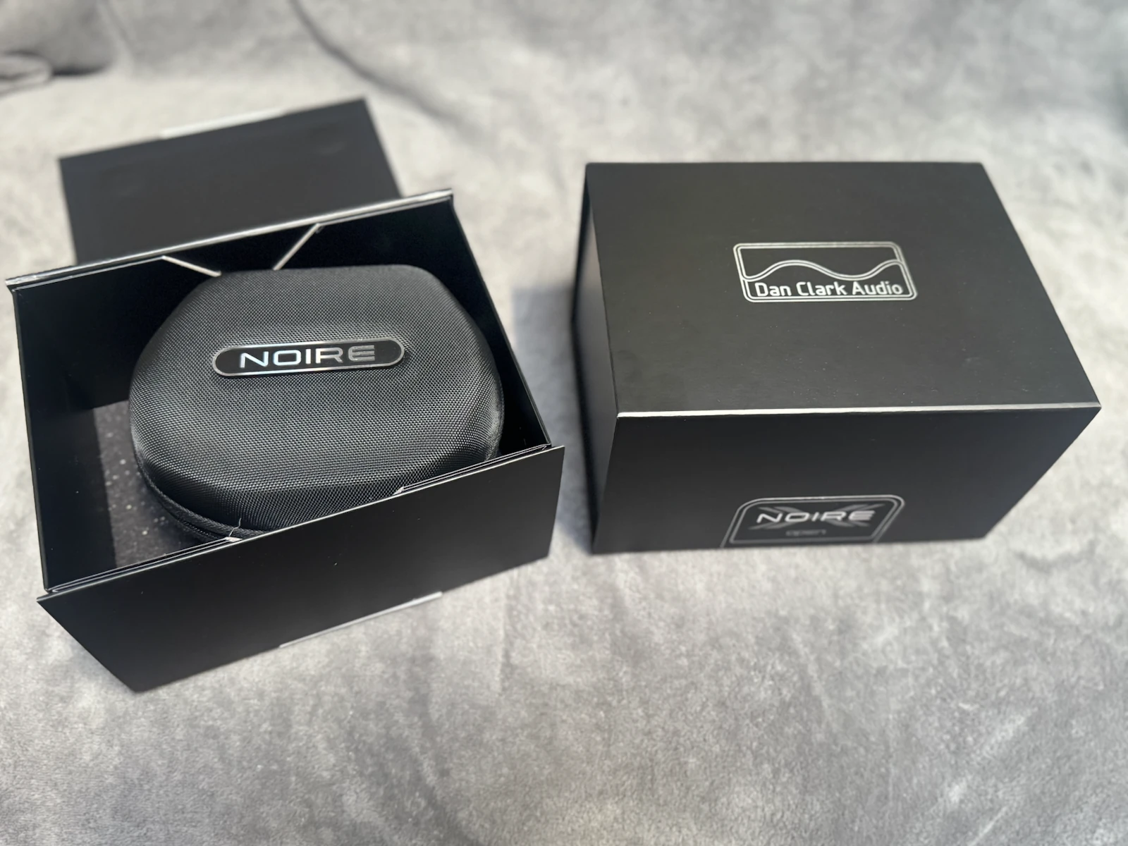 Dan Clark Audio NOIRE X and NOIRE XO product boxes with headphone carrying case