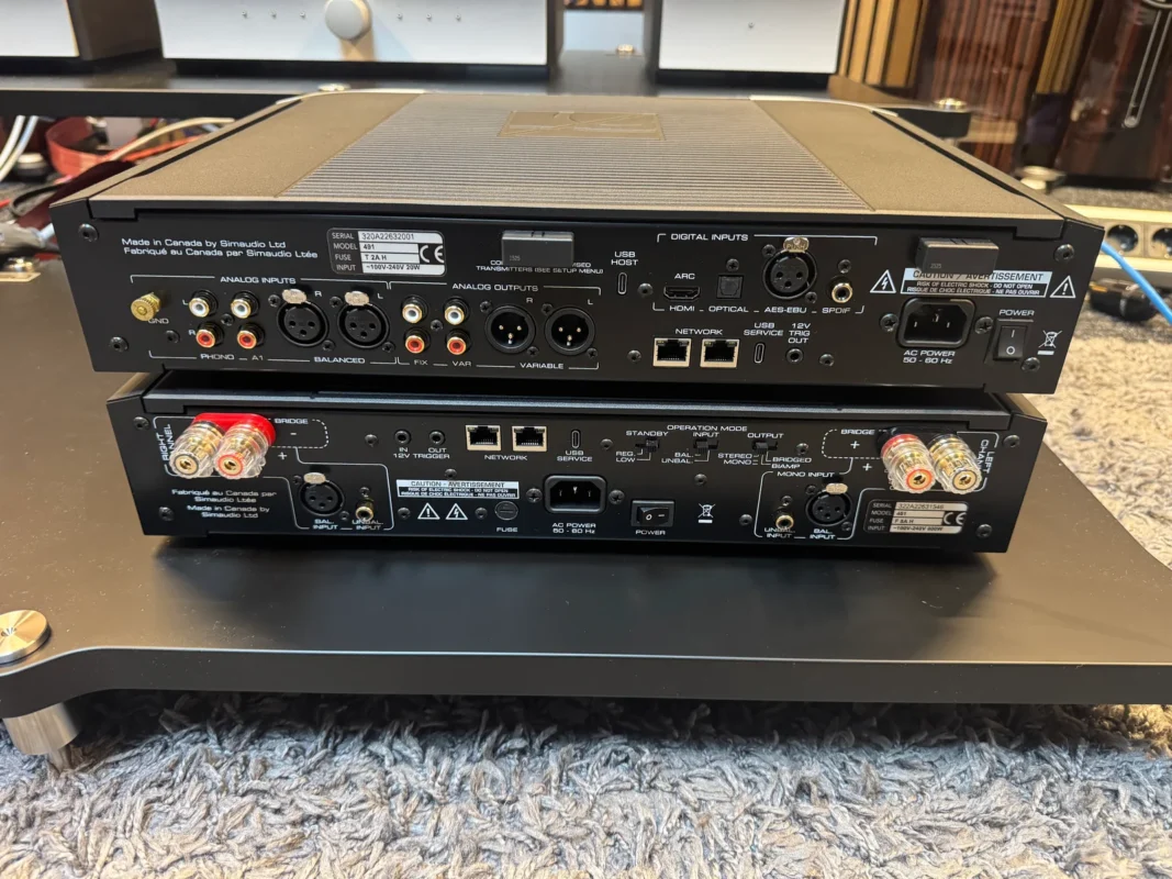 Rear panels of the MOON Compass 491 above the 461, showing audio connections, network ports and speaker terminals.